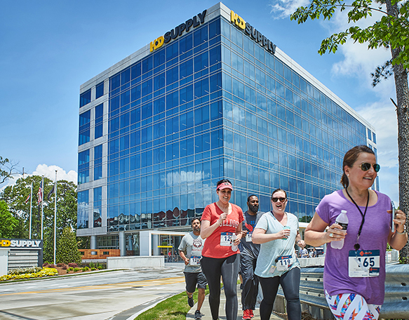 HD Supply associates walking during a charity race along the sidewalks in front of the HD Supply Leadership Development Center in Atlanta, Georgia