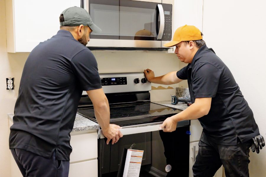maintenance professionals installing an oven