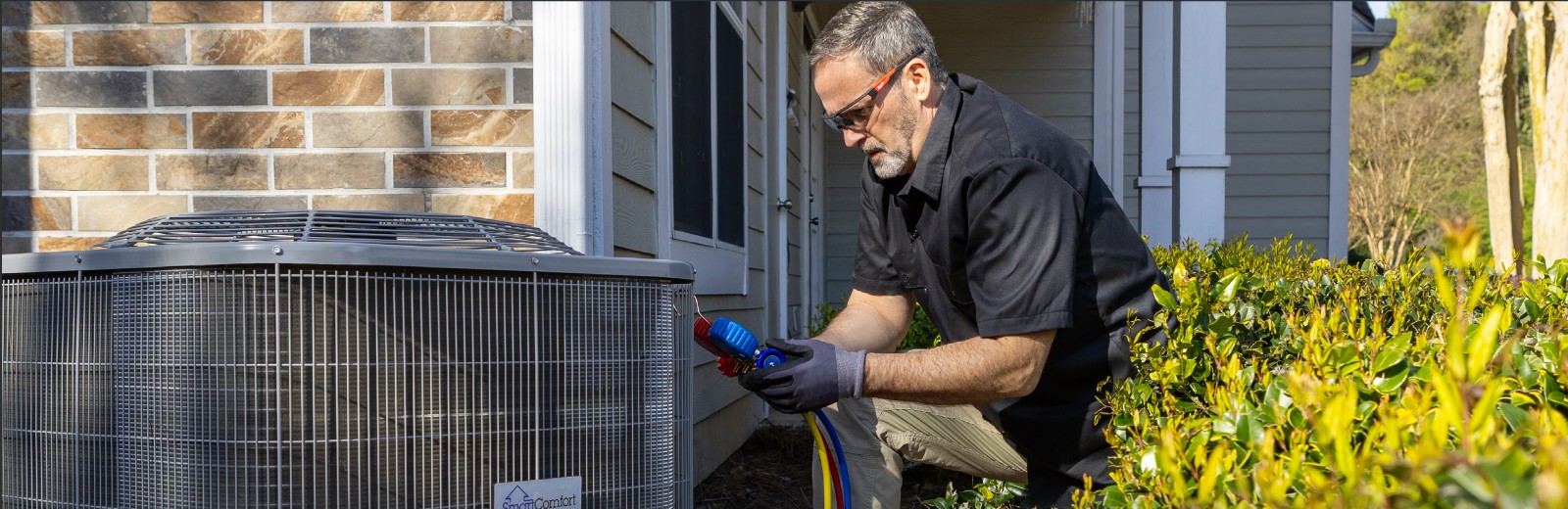 HD Supply On-Demand Services employee installing an outdoor HVAC condenser